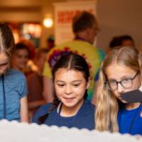 students looking at posters from student project showcase